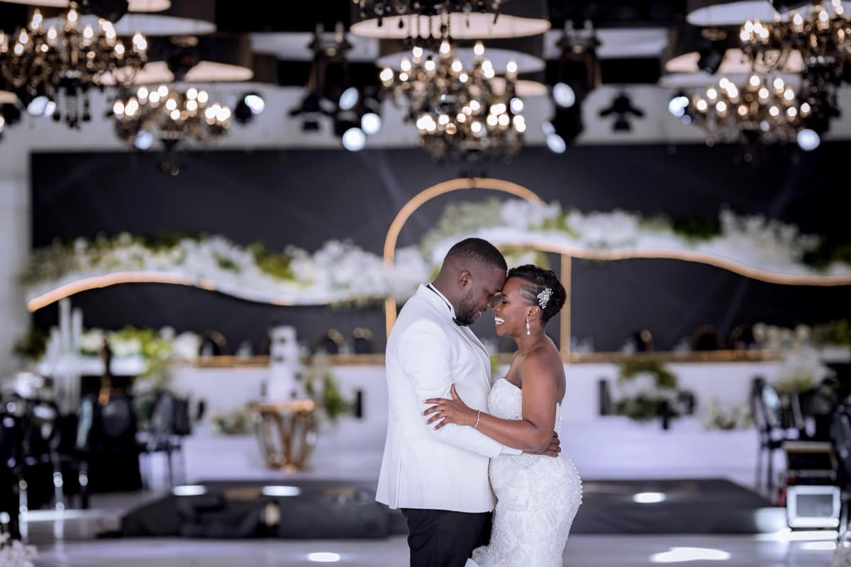 Elegant reception venue with gold chandeliers and floral installations styled by Modern Charm